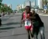 Kenyan runner Edwin Kipsang Rotich tackled by spectator while running 10km race in Brazil